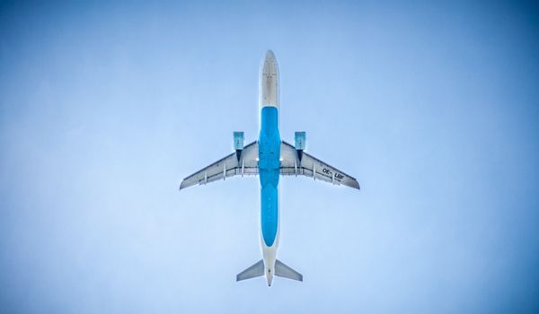 A plane flying over a city downtown